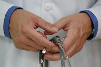 doctor's hands holding stethoscope